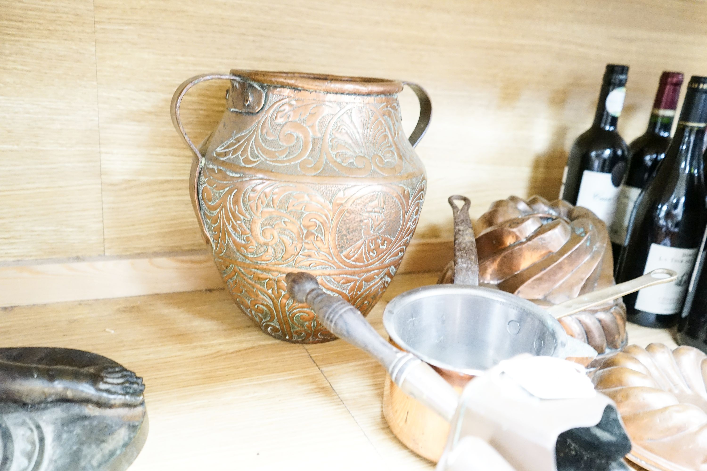 A mixed group of copper wares including Victorian jelly moulds, coal scoops, vase etc
